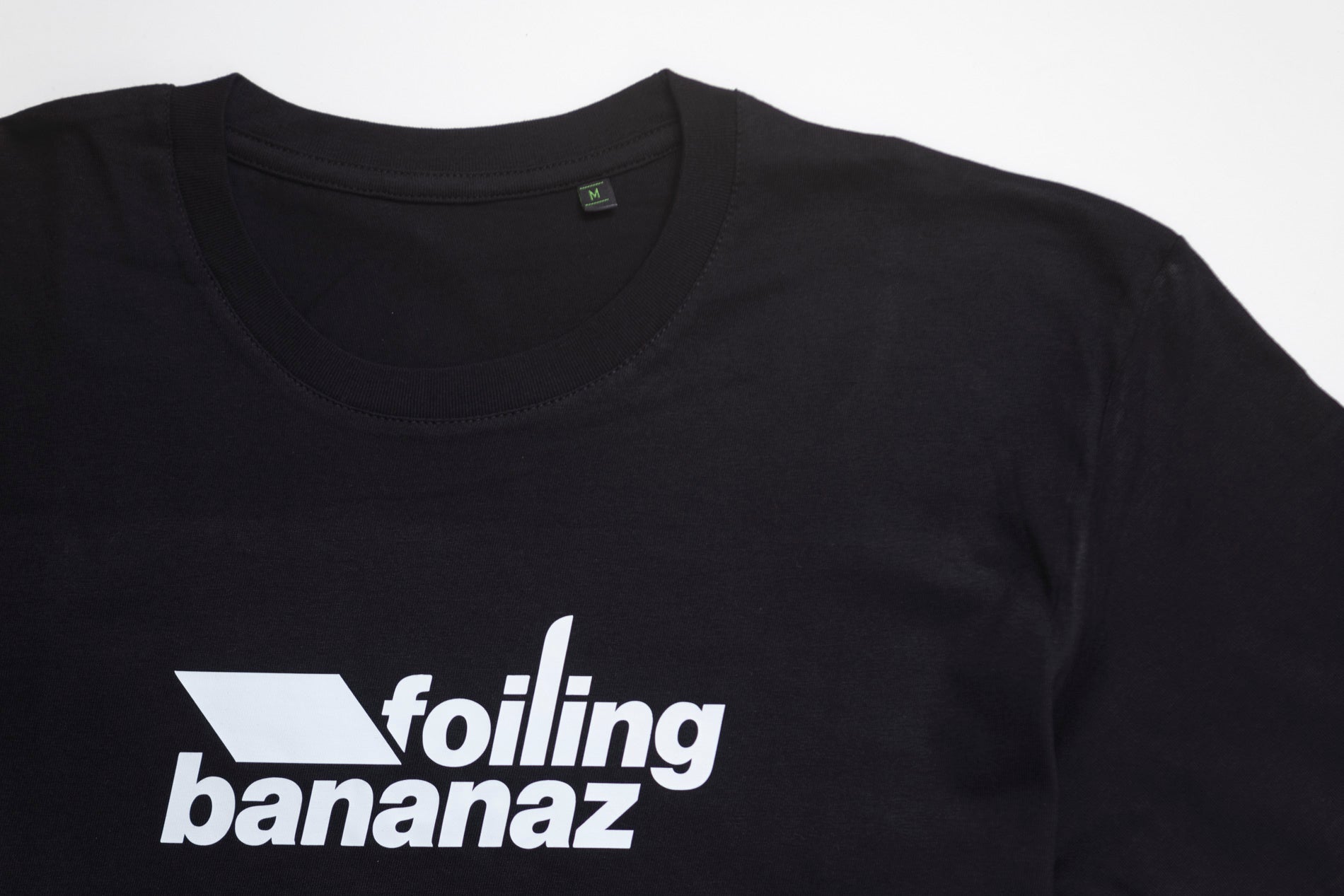 Black tee close upwith Foiling Bananaz white logo